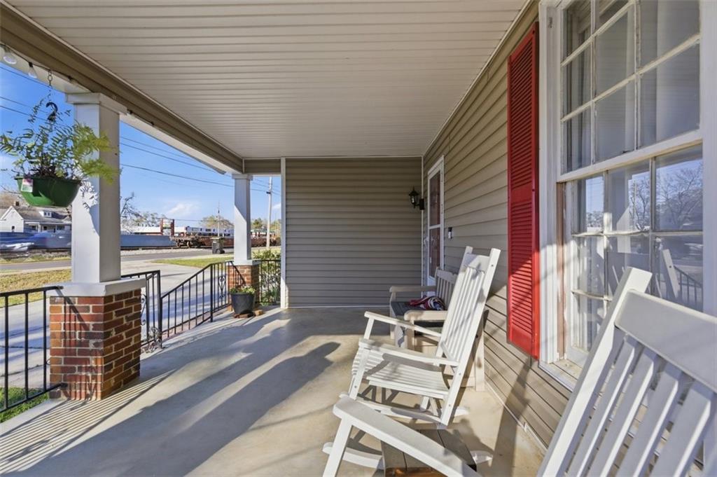 171 Northeast Broad Street Fairburn, GA 30213 - Photo 5 of 15 a view of balcony with wooden floor and outdoor seating