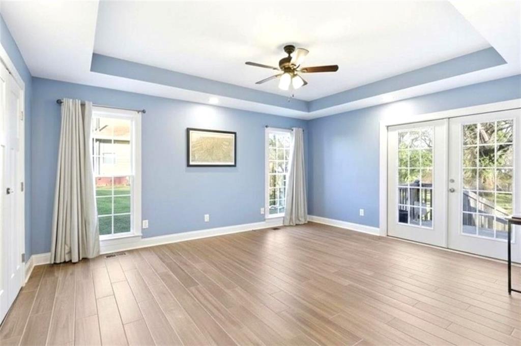 171 Northeast Broad Street Fairburn, GA 30213 - Photo 7 of 15 a view of an empty room with a window and wooden floor