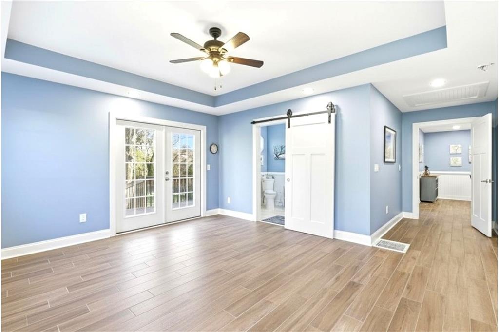 171 Northeast Broad Street Fairburn, GA 30213 - Photo 8 of 15 a view of an empty room with wooden floor