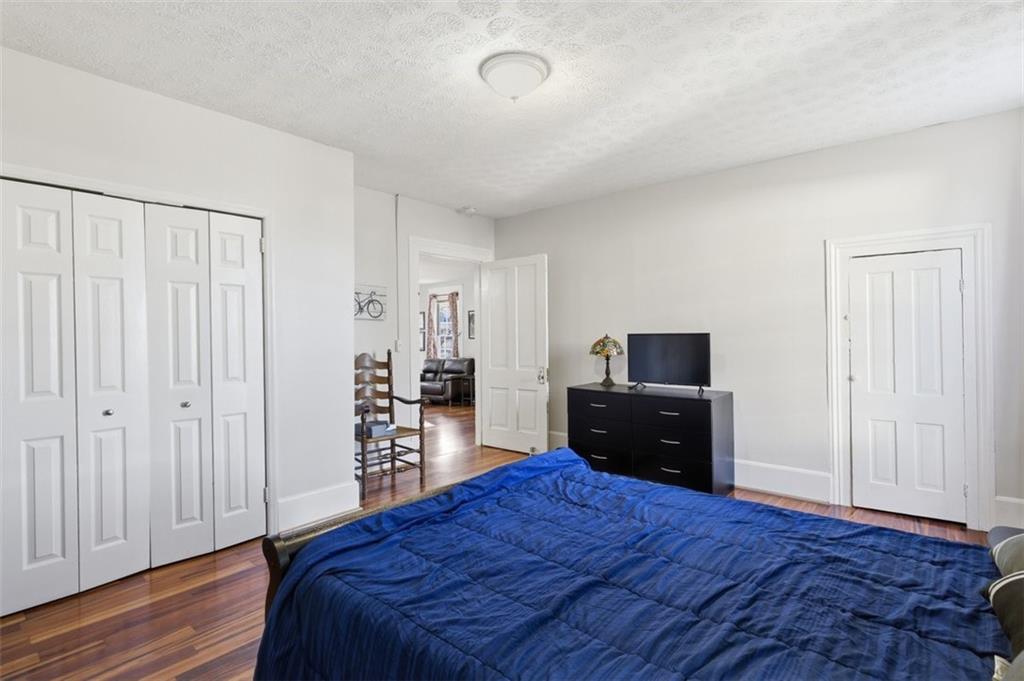 171 Northeast Broad Street Fairburn, GA 30213 - Photo 9 of 15 a bedroom with a bed and a television