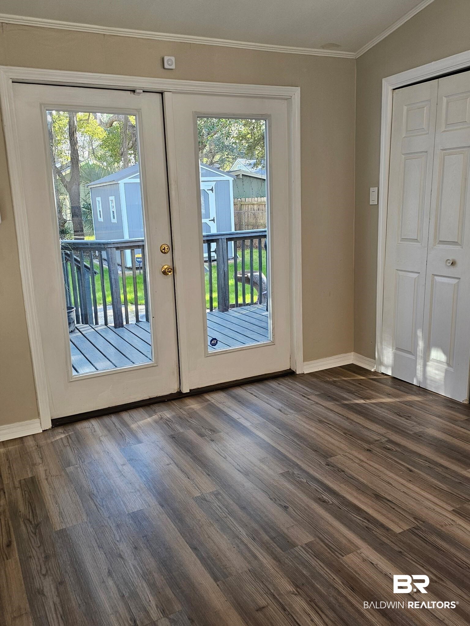 1215 Church Street Mobile, AL 36604 - Photo 11 of 23 Doorway featuring baseboards, french doors, dark wood-type flooring, and crown molding