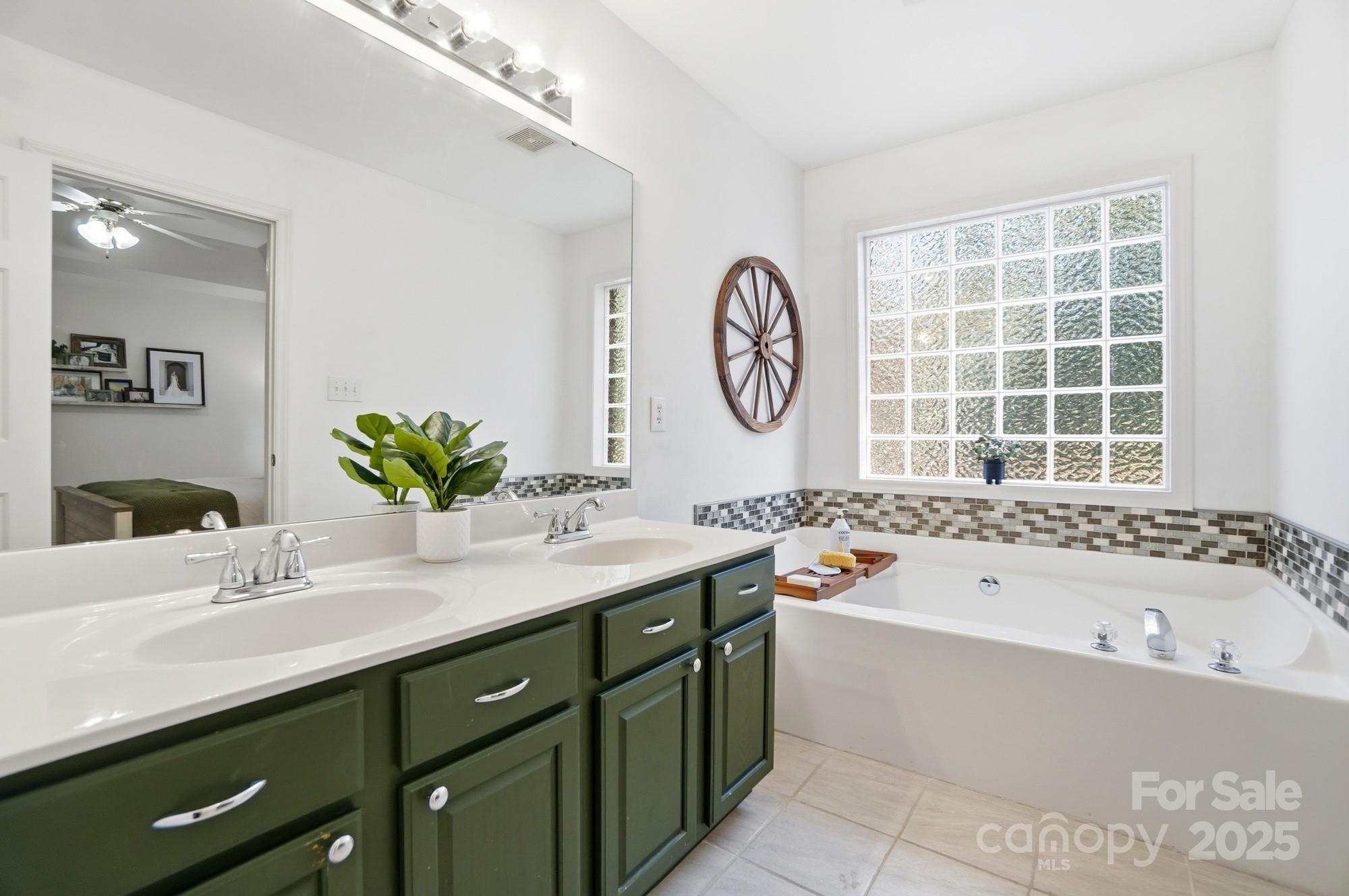 516 Jim Parker Road Monroe, NC 28110 - Photo 19 of 37 a bathroom with a tub sink and mirror