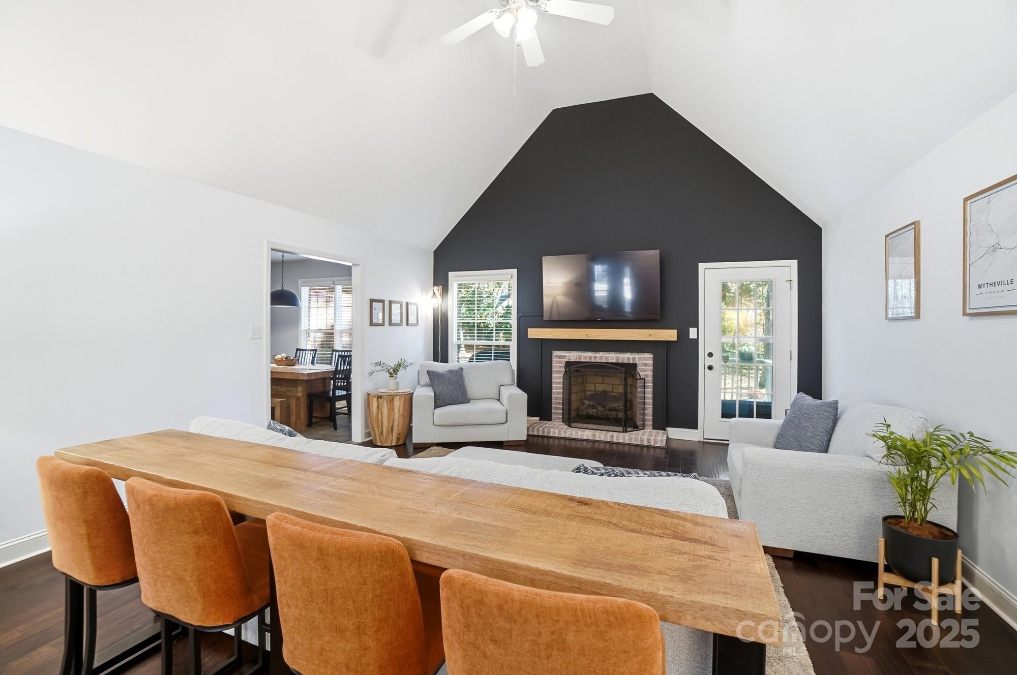 516 Jim Parker Road Monroe, NC 28110 - Photo 7 of 37 a living room with furniture a fireplace and a chandelier