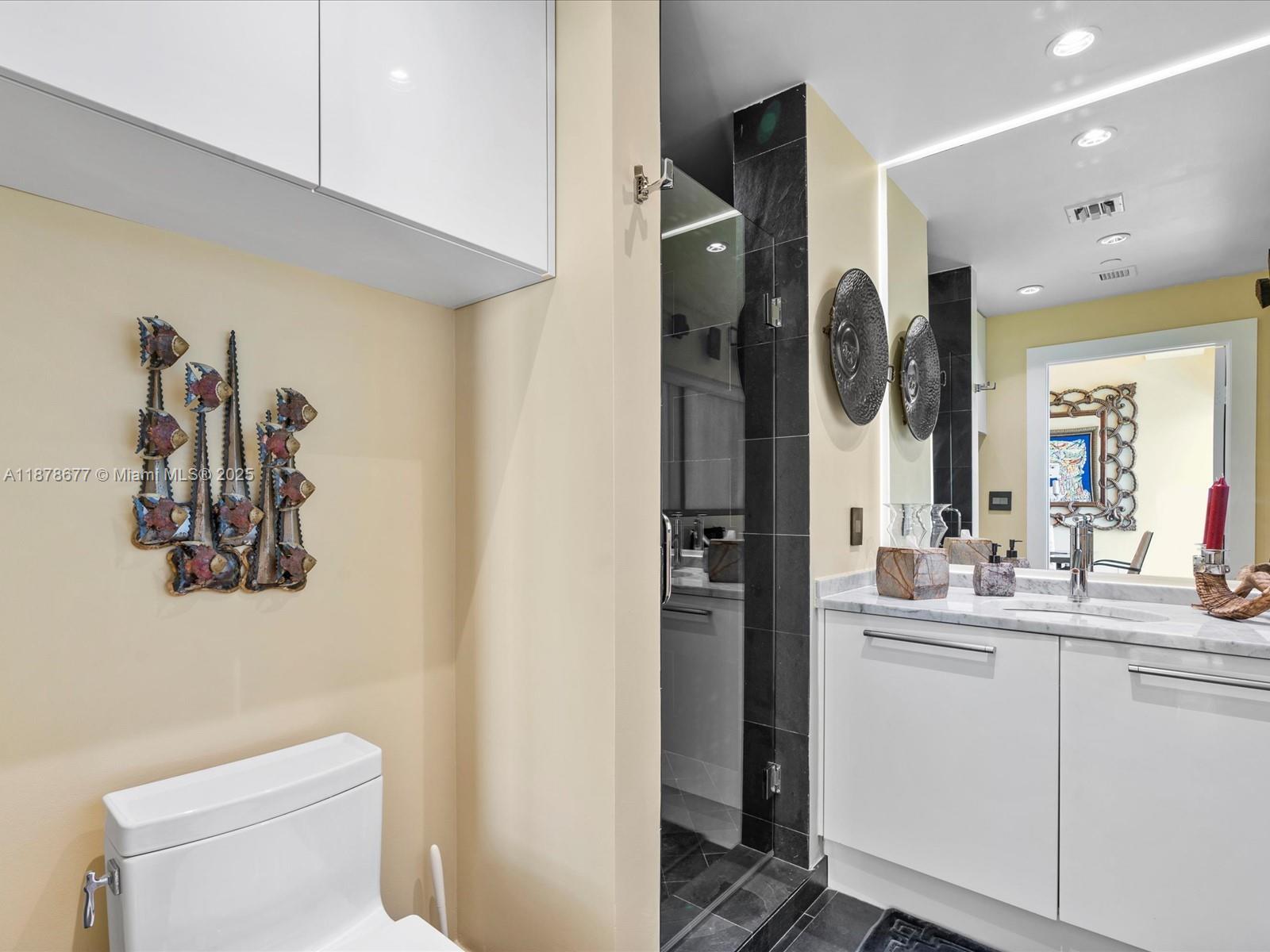 900 Biscayne Boulevard, Unit 3709 Miami, FL 33132 - Photo 37 of 57 a bathroom with a sink and mirror with toilet