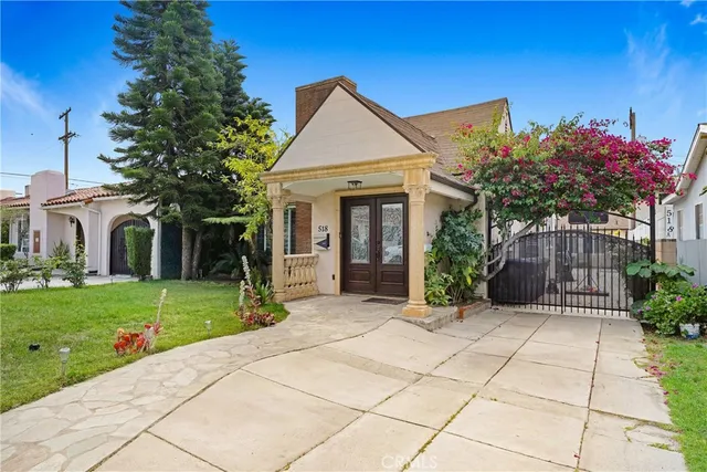 a view of a house with a yard and a garden