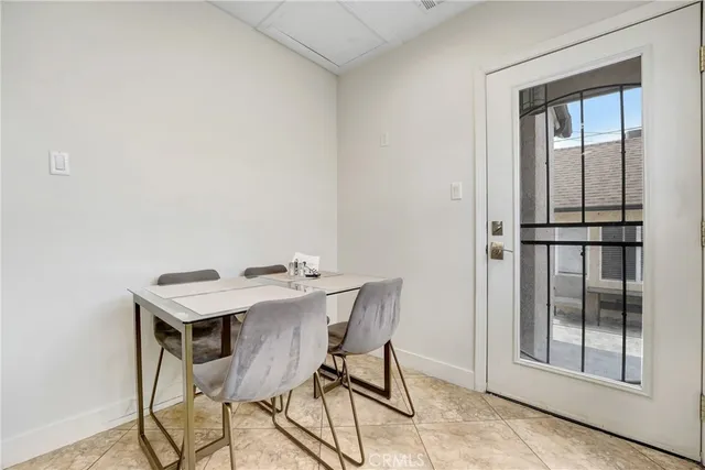 a view of a room that has a table and chairs in it