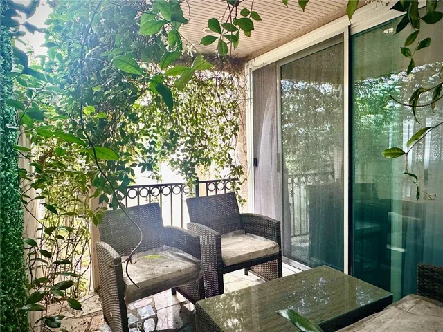 a view of a porch with furniture and a yard