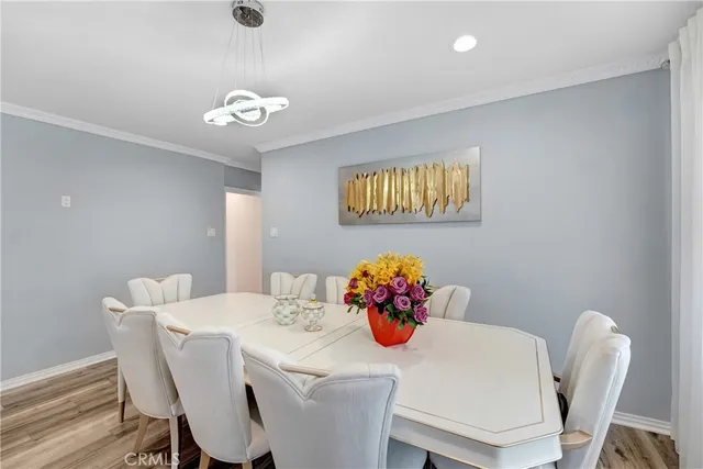 a dining room with furniture and chandelier