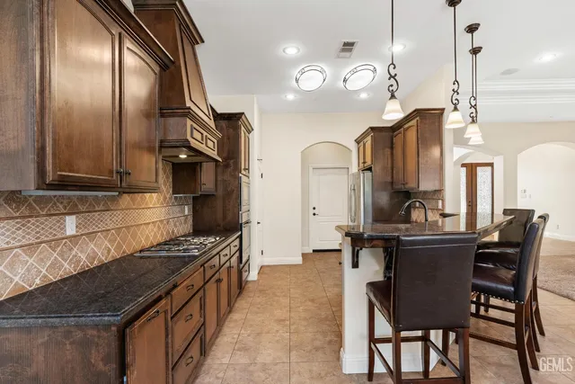 a kitchen with wooden cabinets and a stove top oven