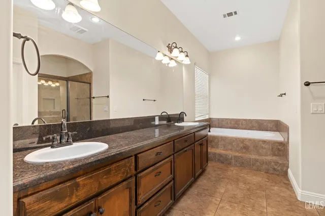 a bathroom with a bathtub and a shower