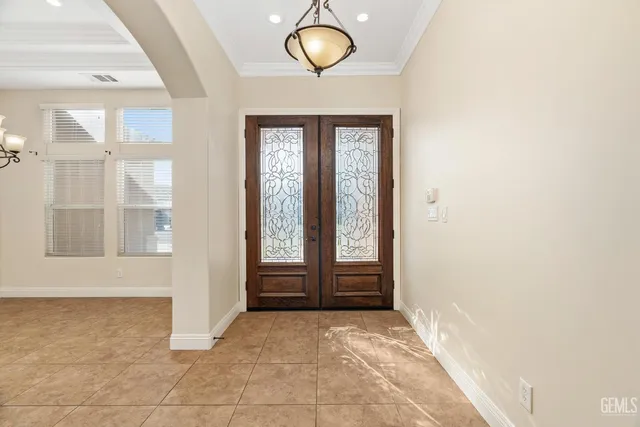 an empty room with windows and front door