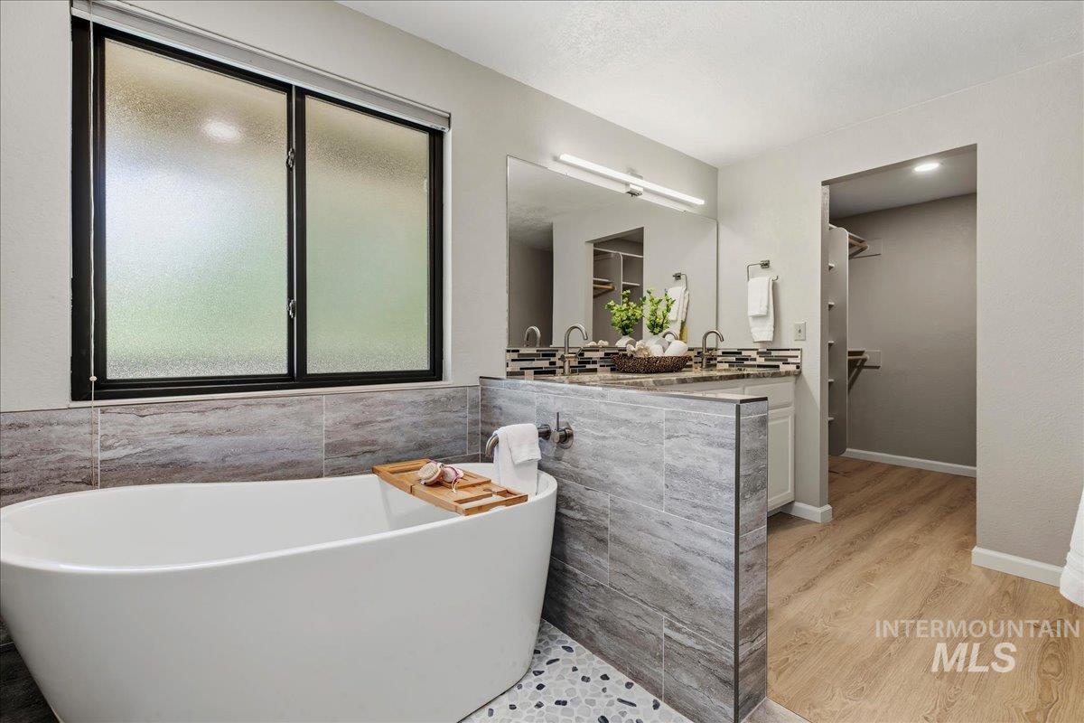 599 Pebble Beach Way Eagle, ID 83616 - Photo 24 of 44 Freestanding soaking tub with gray mosaic tile flooring
