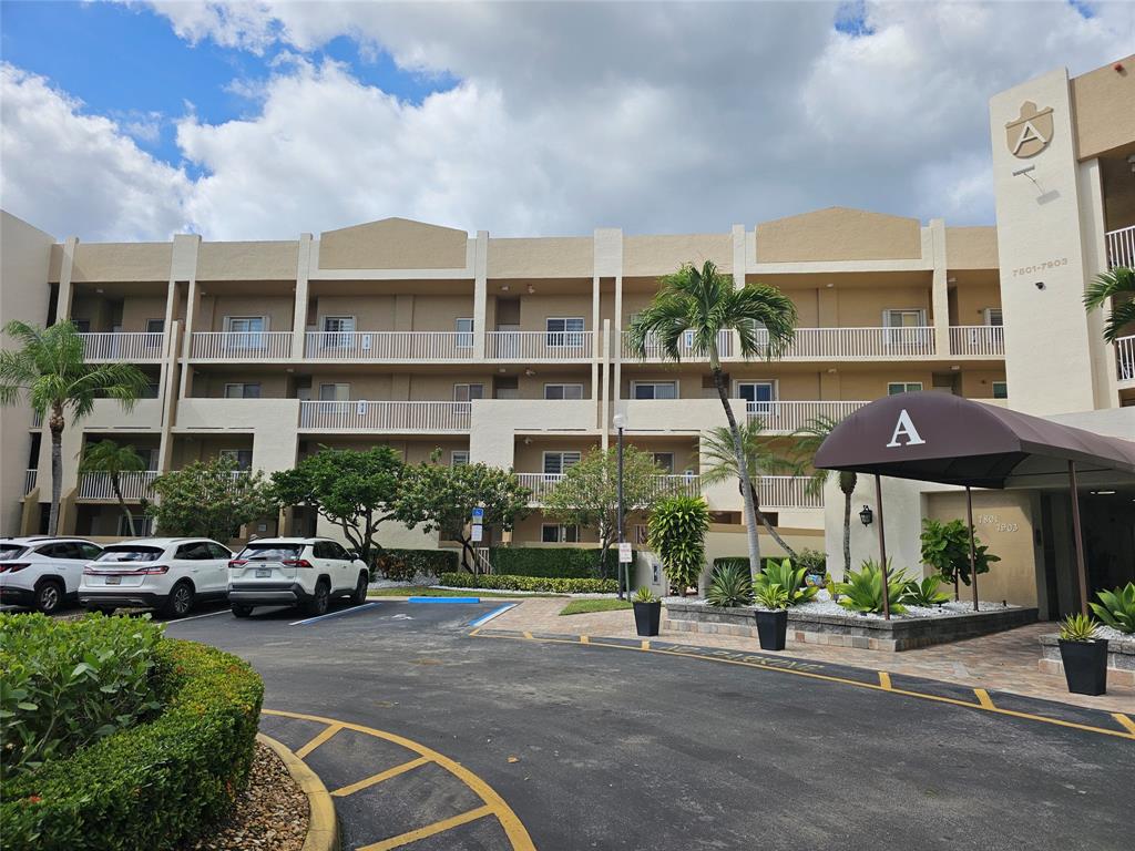 7843 Granville Drive, Unit 7843 Tamarac, FL 33321 - Photo 1 of 26 a front view of a building with street