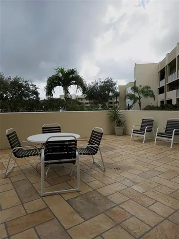 a terrace with outdoor seating and barbeque oven
