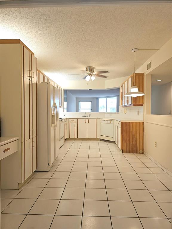 7843 Granville Drive, Unit 7843 Tamarac, FL 33321 - Photo 4 of 26 a view of a kitchen with an empty space and a window