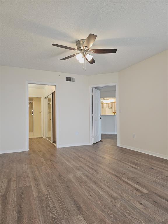 7843 Granville Drive, Unit 7843 Tamarac, FL 33321 - Photo 10 of 26 a view of an empty room with window and wooden floor