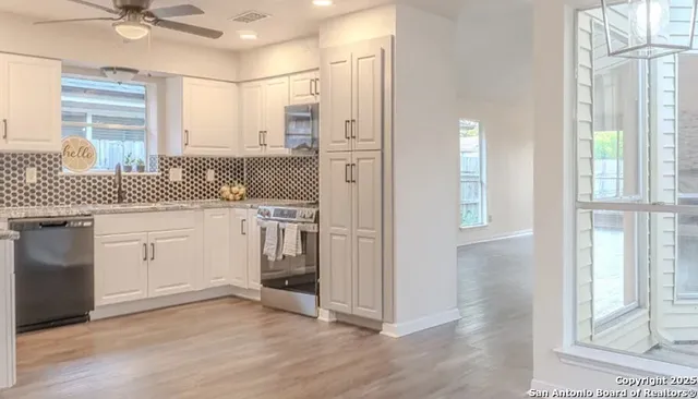 a kitchen with a sink cabinets and window