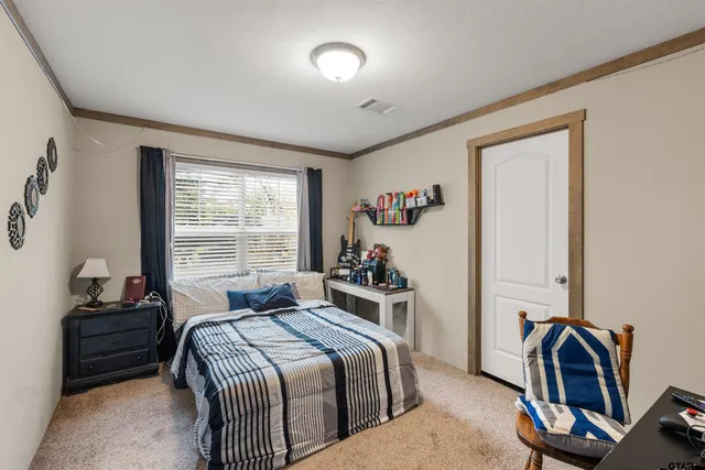 a bedroom with a bed and a window