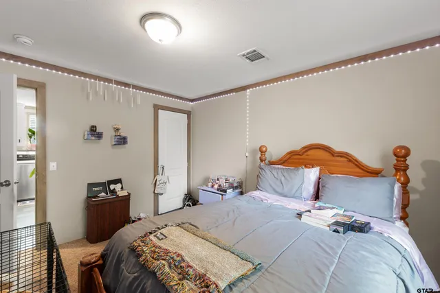 a bedroom with a bed and a view of bedroom