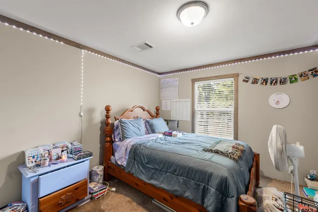 a bedroom with a bed and a window