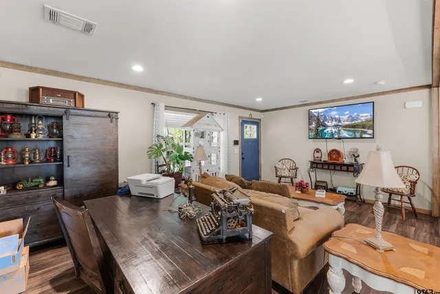 a room with furniture wooden floor and a potted plant