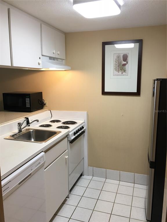 36750 Highway 19, Unit 13214 Palm Harbor, FL 34684 - Photo 4 of 13 a view of a kitchen with a sink and a stove top oven
