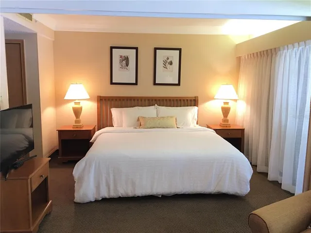 a bedroom with a bed and night stand