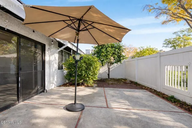 a blue and white umbrella sitting in front of a door