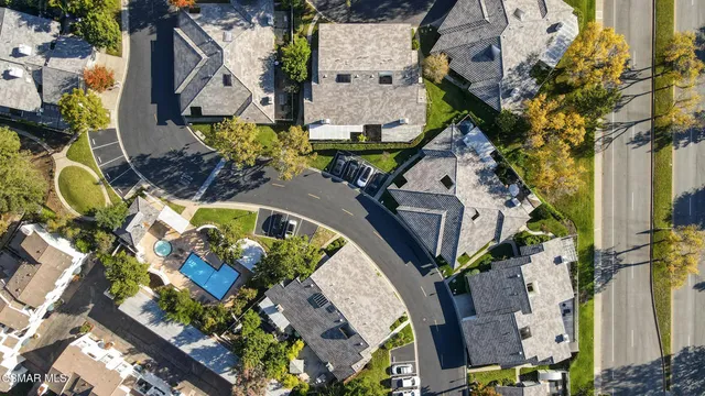 an aerial view of residential house with outdoor space and swimming pool