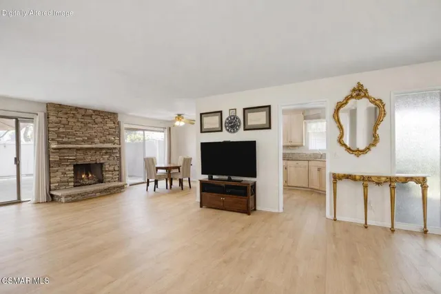 a living room with furniture a fireplace and a flat screen tv
