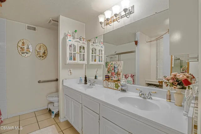 a bathroom with a sink mirror and toilet