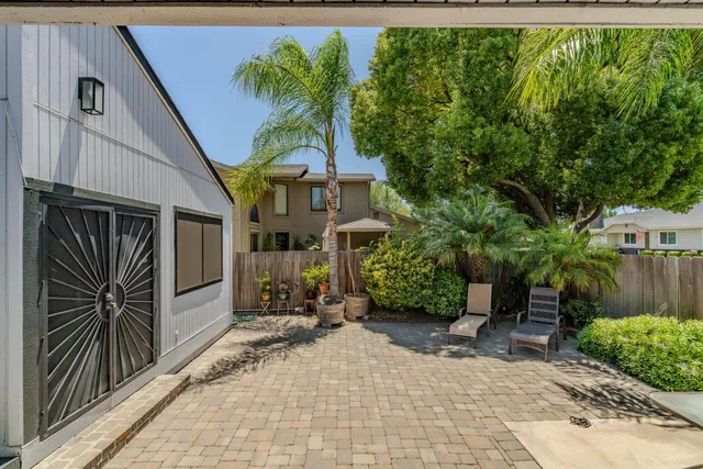 a kitchen with stainless steel appliances granite countertop wooden floors wooden cabinets a sink and a stove
