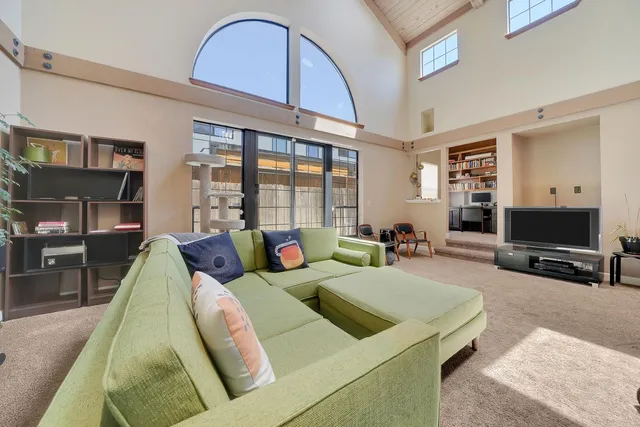 a bedroom with a bed couch and window