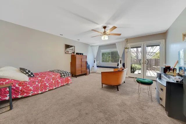 a view of staircase with lots of frames on wall and a window