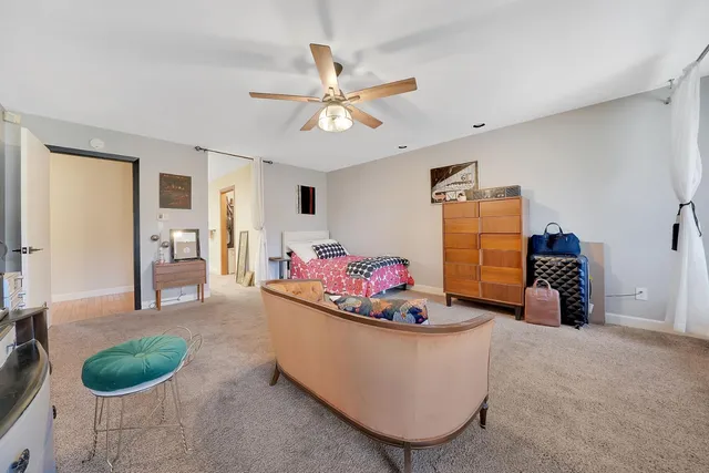 a view of a workspace with furniture and a bedroom