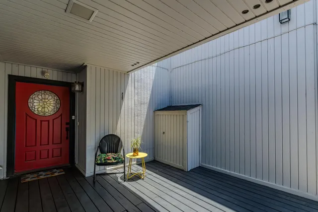 a view of a kitchen with a refrigerator and a stove top oven