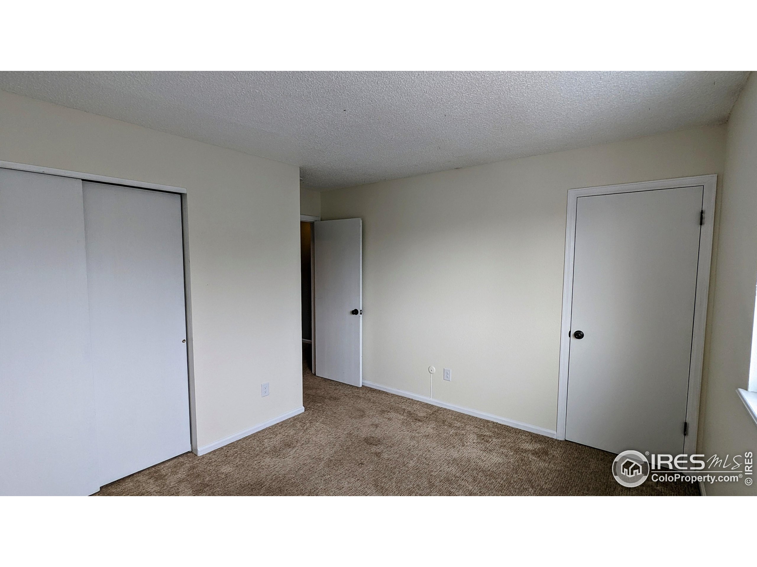 2924 Ross Drive, Unit 19 Fort Collins, CO 80526 - Photo 22 of 28 a open living room with a wooden floor