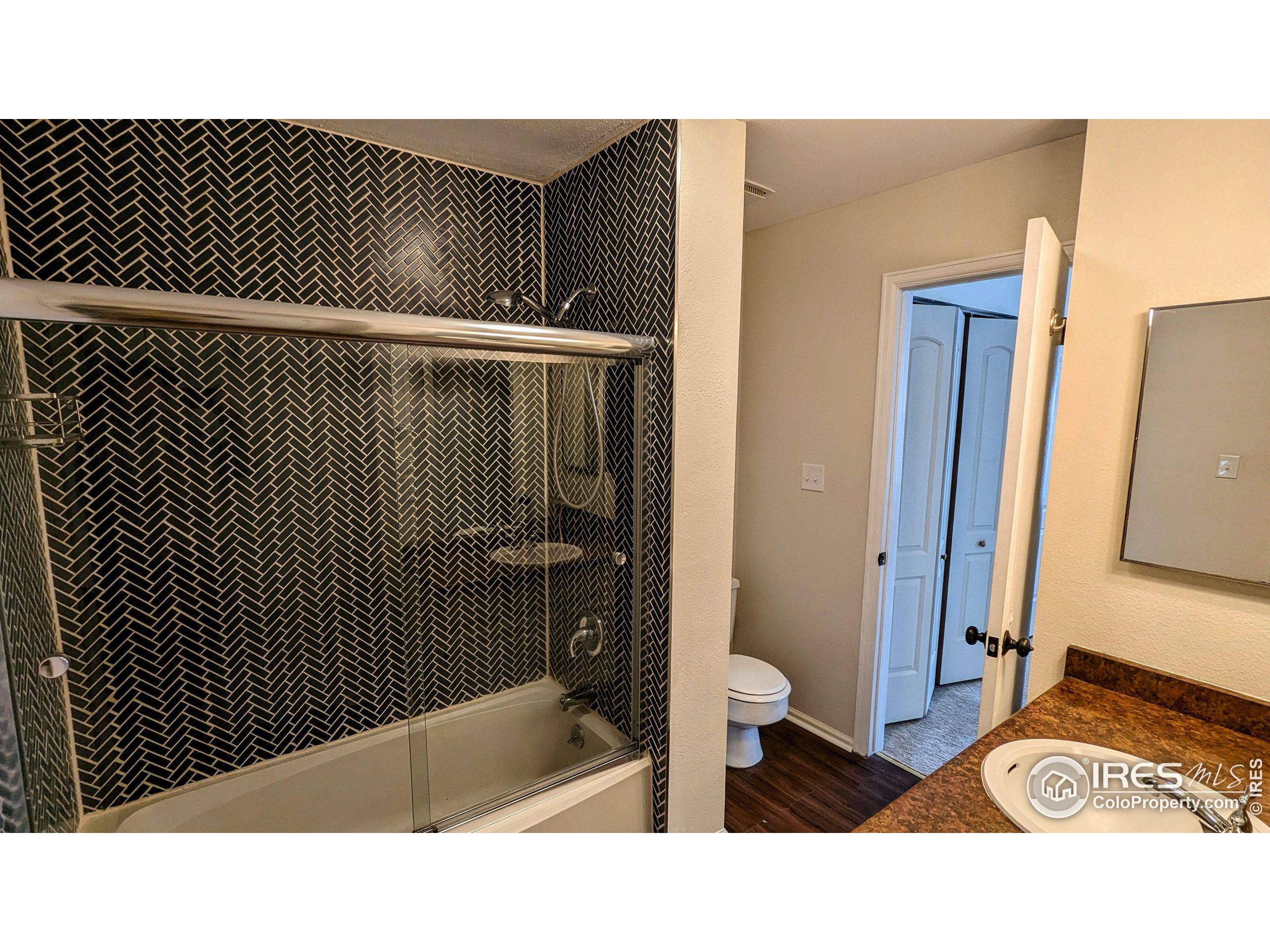 2924 Ross Drive, Unit 19 Fort Collins, CO 80526 - Photo 23 of 28 a bathroom with a sink and a mirror