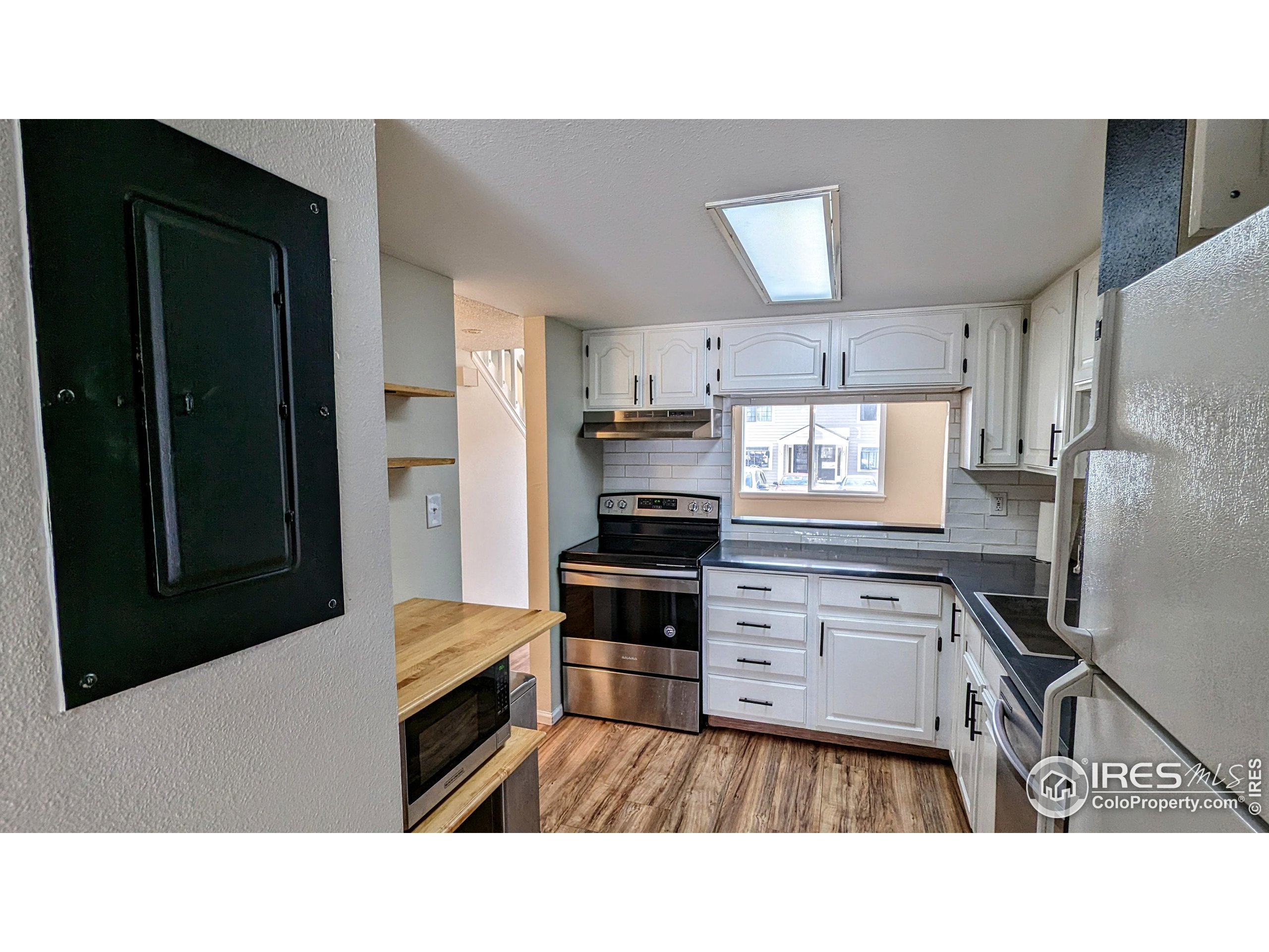 2924 Ross Drive, Unit 19 Fort Collins, CO 80526 - Photo 7 of 28 a kitchen with a refrigerator a stove top oven a sink and dishwasher