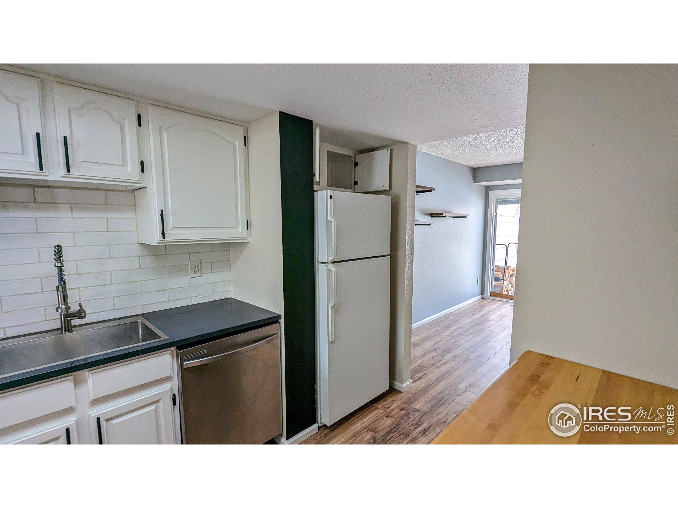 2924 Ross Drive, Unit 19 Fort Collins, CO 80526 - Photo 8 of 28 a kitchen with a refrigerator and a sink