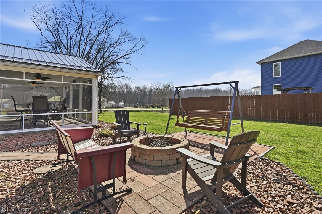 6655 Ceramic Road Crooksville, OH 43731 - Photo 28 of 34 View of patio / terrace featuring a fire pit, a ceiling fan, and a sunroom