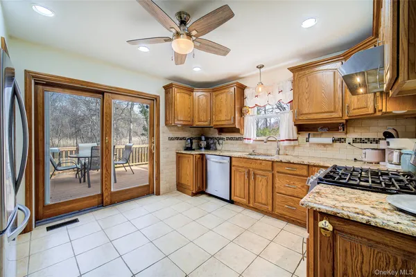 a kitchen with stainless steel appliances granite countertop a stove sink and cabinets