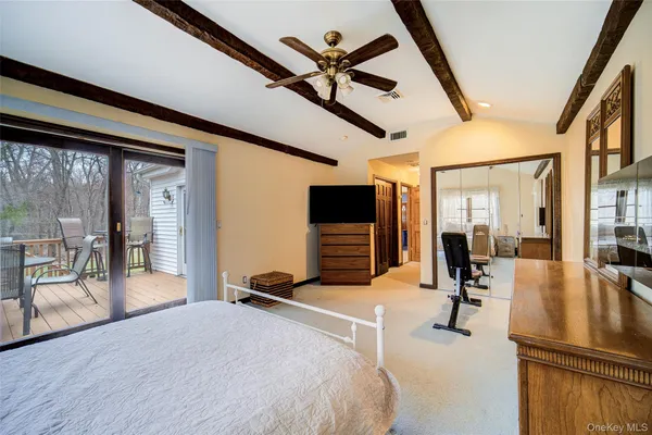 a bedroom with furniture and a large window