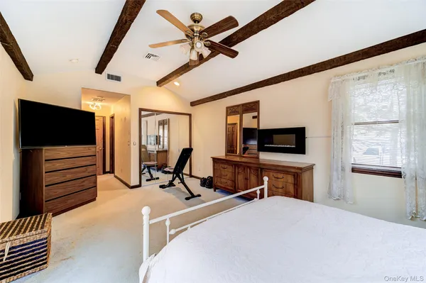 a bedroom with furniture and a flat screen tv