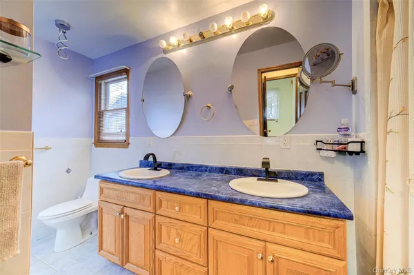 a bathroom with a toilet a sink and a mirror