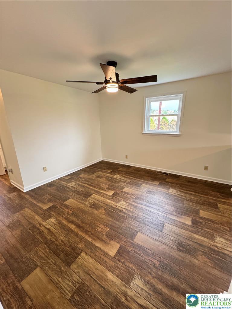 5460 Interchange Road Lehighton, PA 18235 - Photo 9 of 22 an empty room with wooden floor ceiling fan and windows
