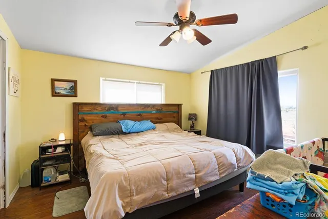 a bedroom that has a bed and a table in it