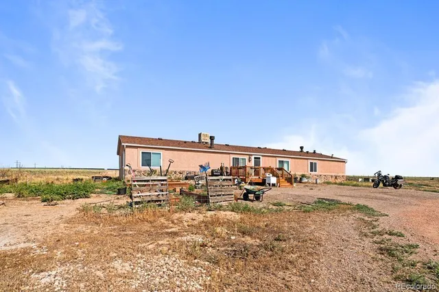 a view of a roof deck with wooden fence and a bench