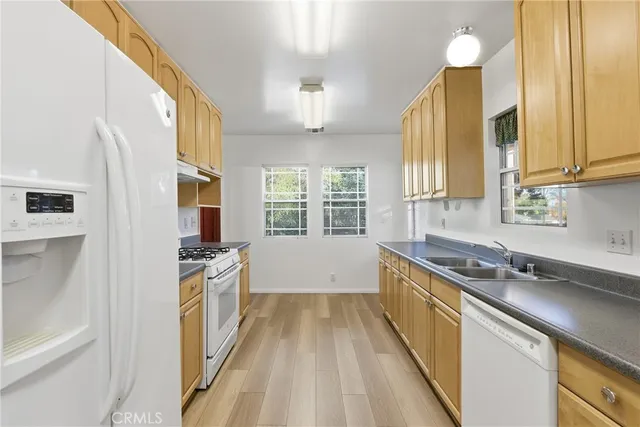 a kitchen with stainless steel appliances a sink stove and cabinets