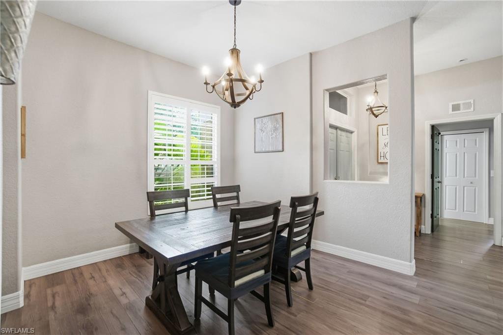 2900 Orange Grove Trail Naples, FL 34120 - Photo 11 of 46 a view of a dining room with furniture window and wooden floor